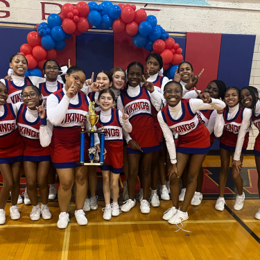 Photo of Christiana HS cheerleaders with trophy